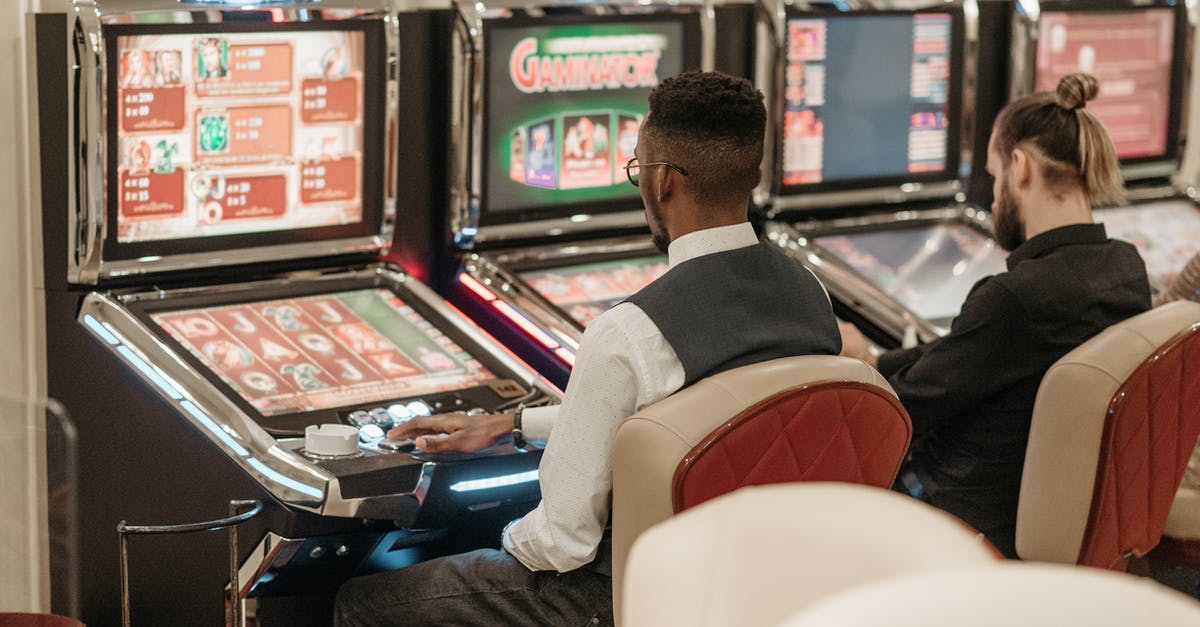 6 Player X-Men Arcade Cabinet Compatibility - Men Sitting in Front of a Slot Machine