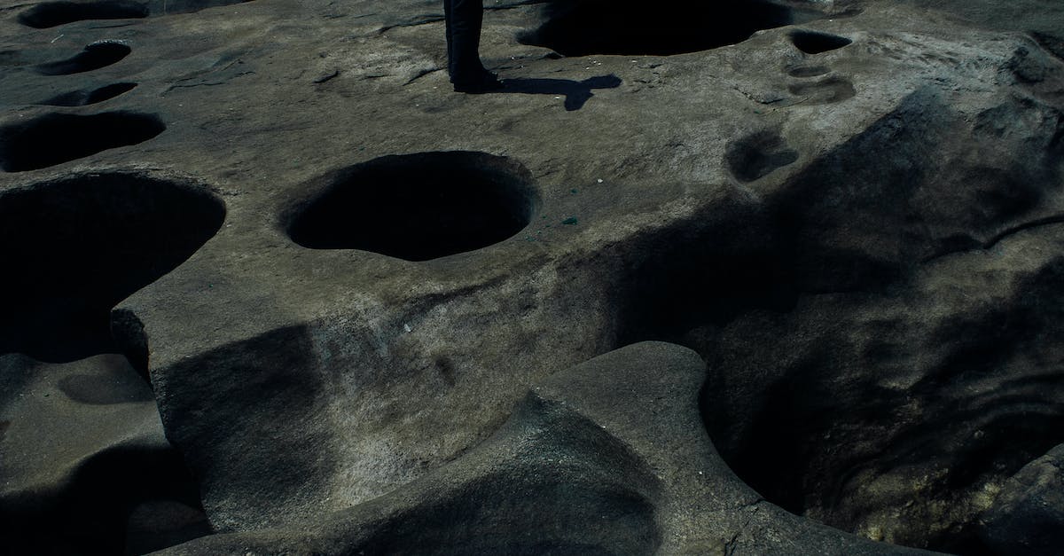 Accidentally dropped boulder in wrong hole in the distortion world - Hole in stony ground with boulders