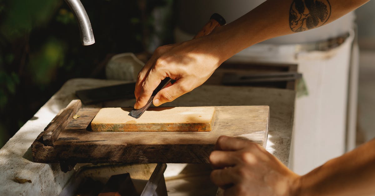 Allow players to automatically "Jump" from level X to level X+n - High angle of crop anonymous tattooed woodworker flattening wooden block with sharp tool on old washbasin in sunlight