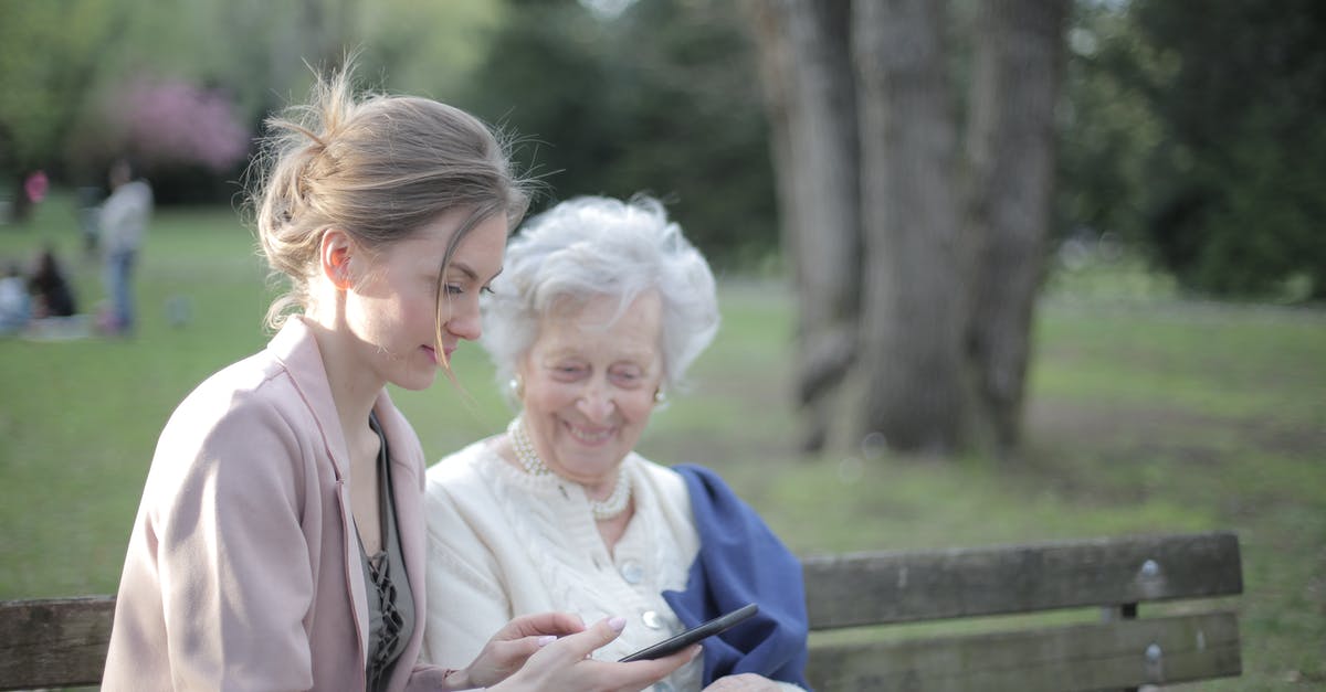 Am I using the stamina skills wrong in Elder Scrolls Blades? - Side view of smiling adult female helping aged mom in using of mobile phone while sitting together in park