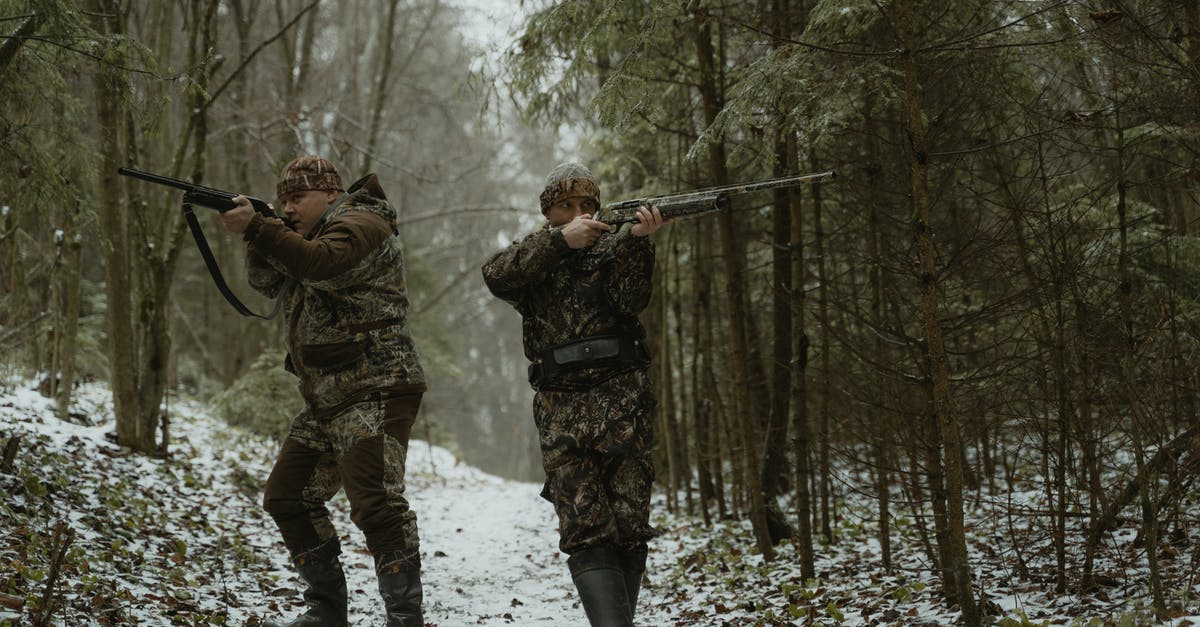 Ammo Conservation for Plasma Weapons - Two Men Standing in the Woods Aiming Their Rifles