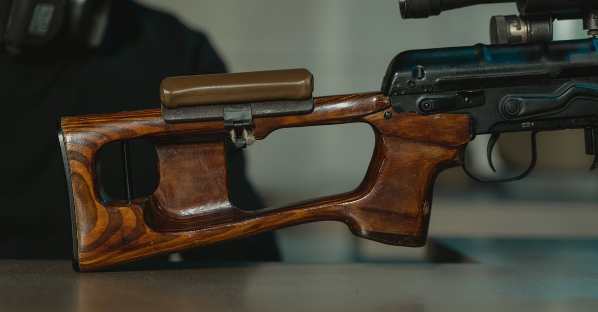 Any way to see weapon stats? - Black and Brown Semi Automatic Pistol on White Table