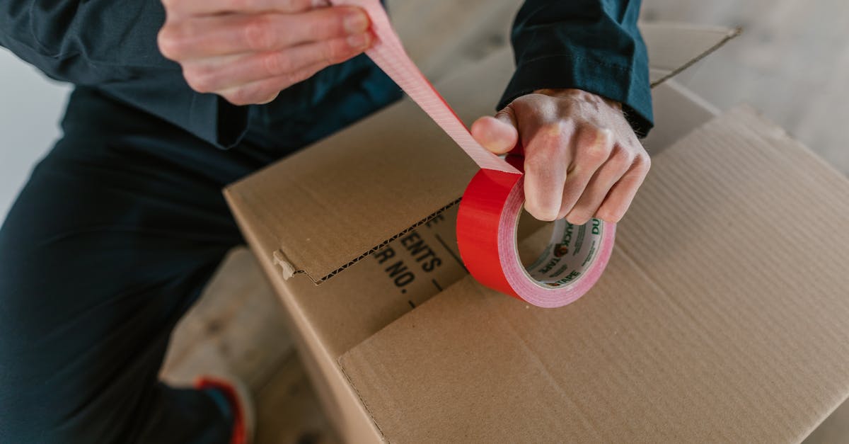 Are Holo-Packs predetermined? - A Person Holding Red Packaging Tape