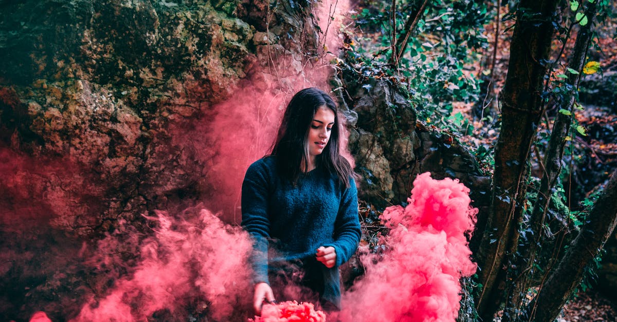 Are Smoke Grenades cumulative? - Woman Wearing Blue Long Sleeved Shirt Standing On Pink Smoke