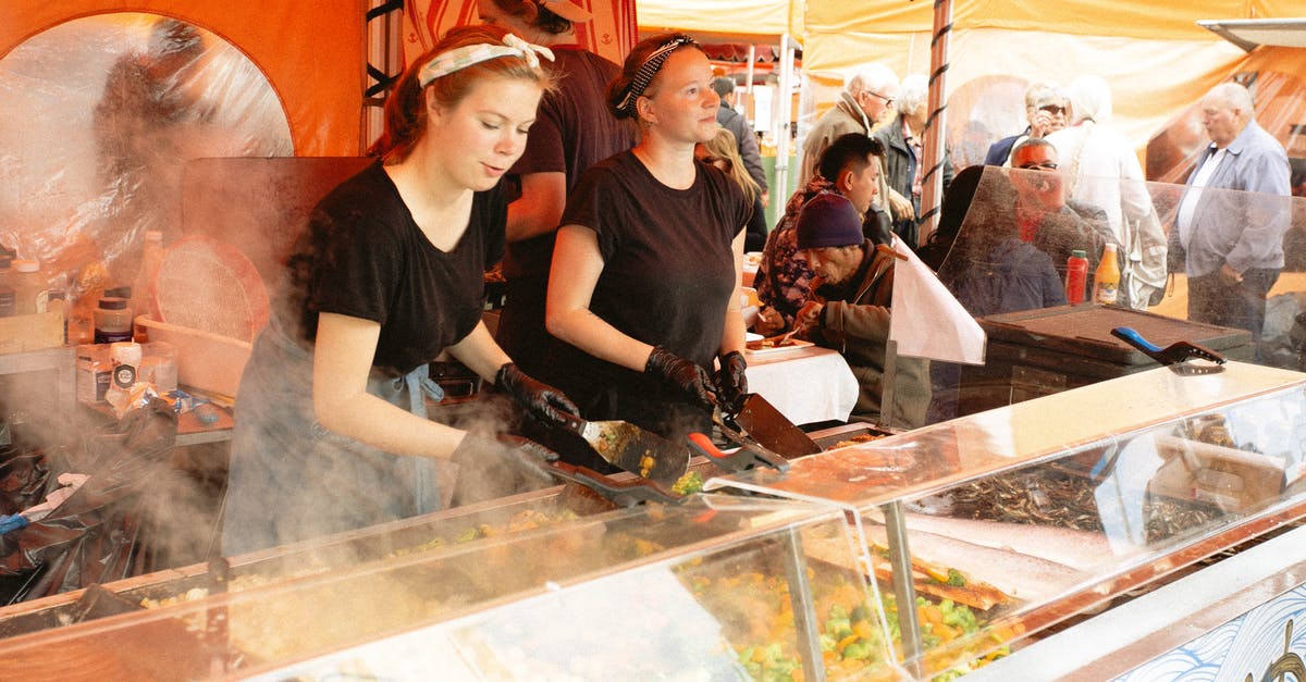 Are there any benefits to food that isn't favoured by anything? - Women in Black Shirt Selling Food in Food Stall