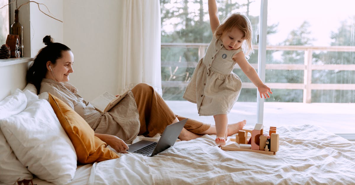 Are there any trade restrictions between the fourth generation Pokémon games? - Mother and daughter using resting in bedroom with laptop and toy