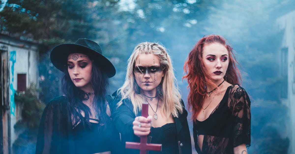 Are there any ways to overcome a spells spell power cap? - Spooky females in dark clothes with inverse cross standing together in blue colored smoke agains trees