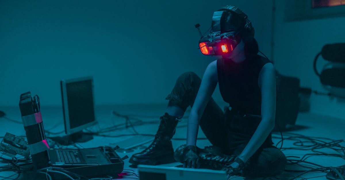 Are there enemies immune to quickhacks in Cyberpunk 2077? - A Person Sitting on the Floor with Vr Goggles Using a Computer