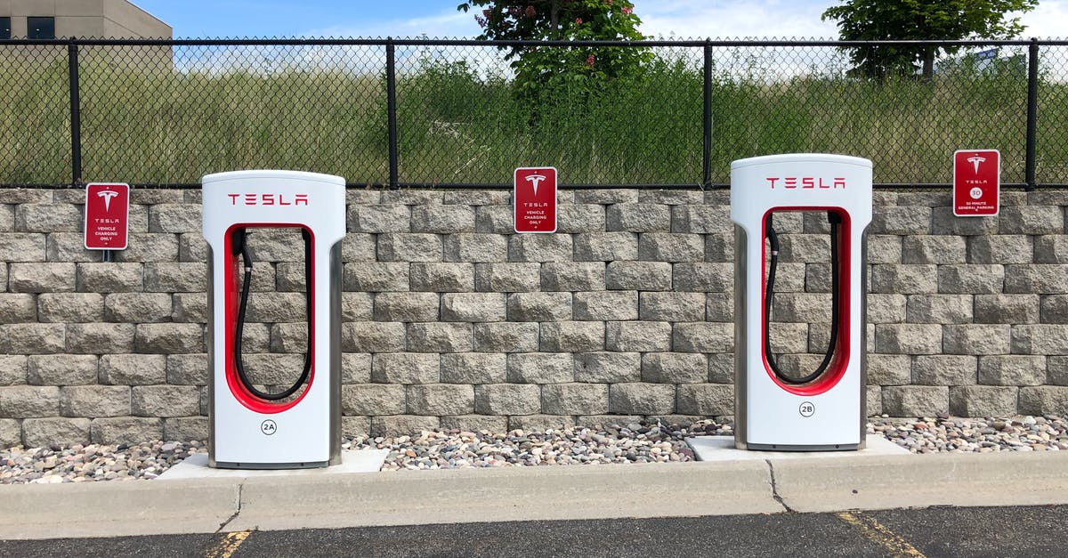 Auto-dismissed plot text - Two White and Red Tesla Charging Station