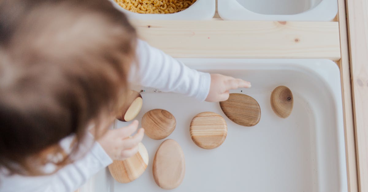 BDO - How do I get more lodging for my workers? - Crop anonymous child getting brown stones from white container at home BDO - How do I get more lodging for my workers? - Crop anonymous child getting brown stones from white container at home