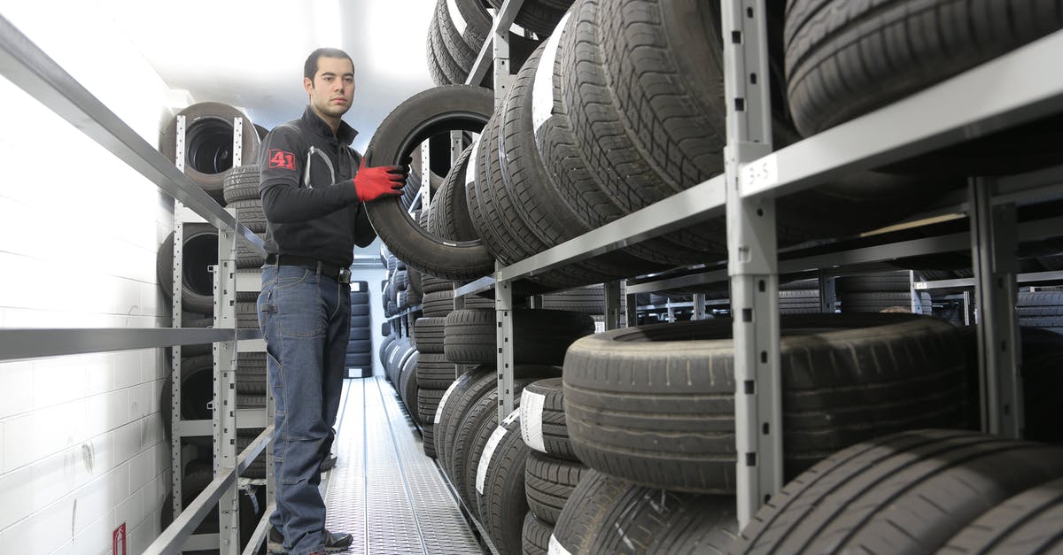 Benefits of holding many souls at once - Man in Black Jacket Standing Beside Black Tires