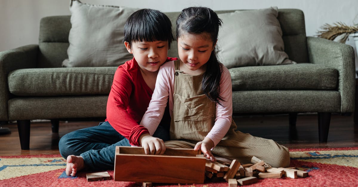 Block rotation preview box - Cute barefoot ethnic kids playing jenga at home