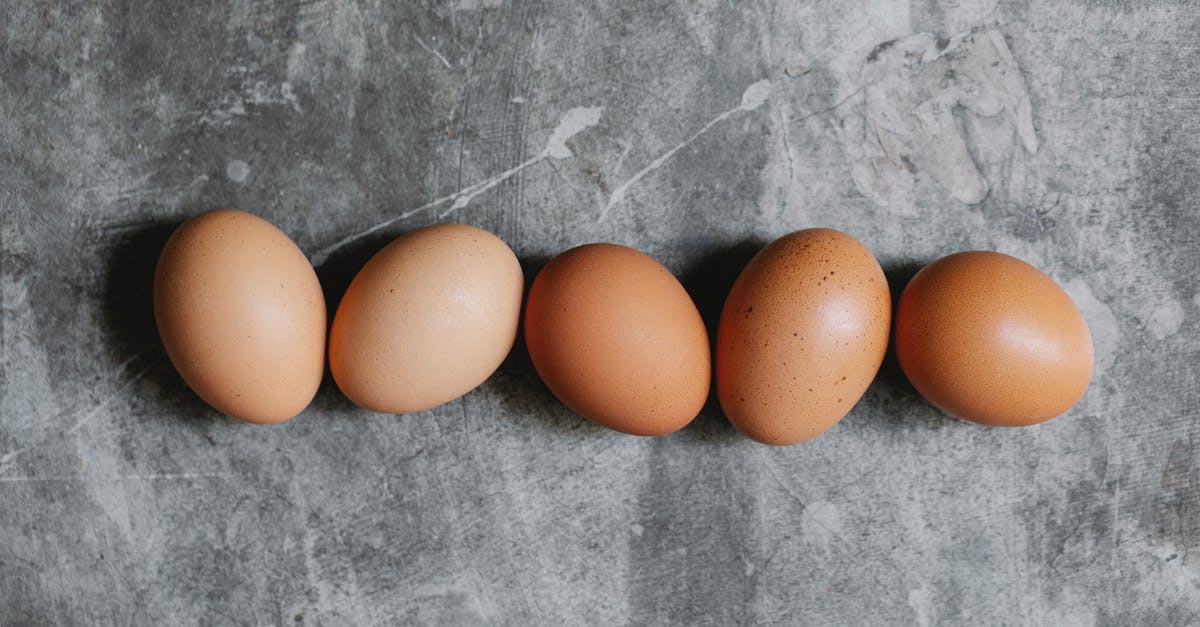 Brown Chickens and egg frequency - Whole raw brown eggs arranged on table in kitchen