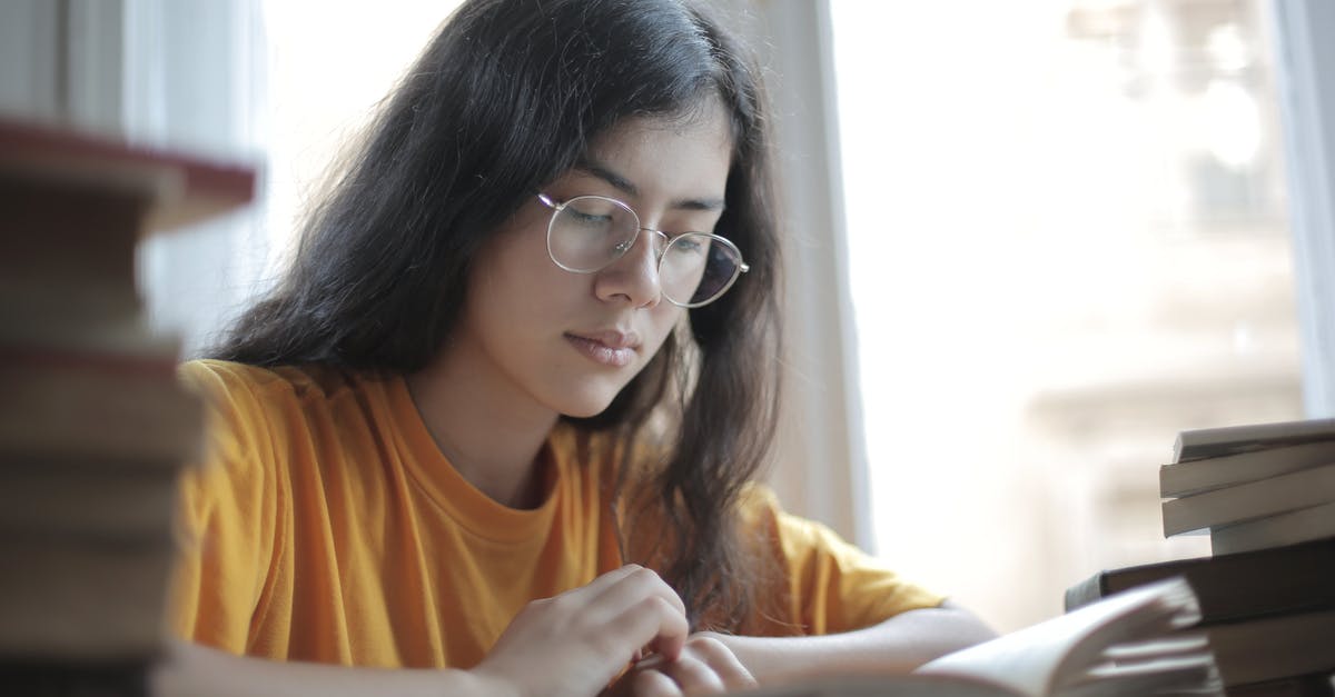 Can't join any Servers on PC Minecraft - Low angle of diligent ethnic female student wearing casual t shirt and eyeglasses sitting at table with stacks of books and preparing for exam