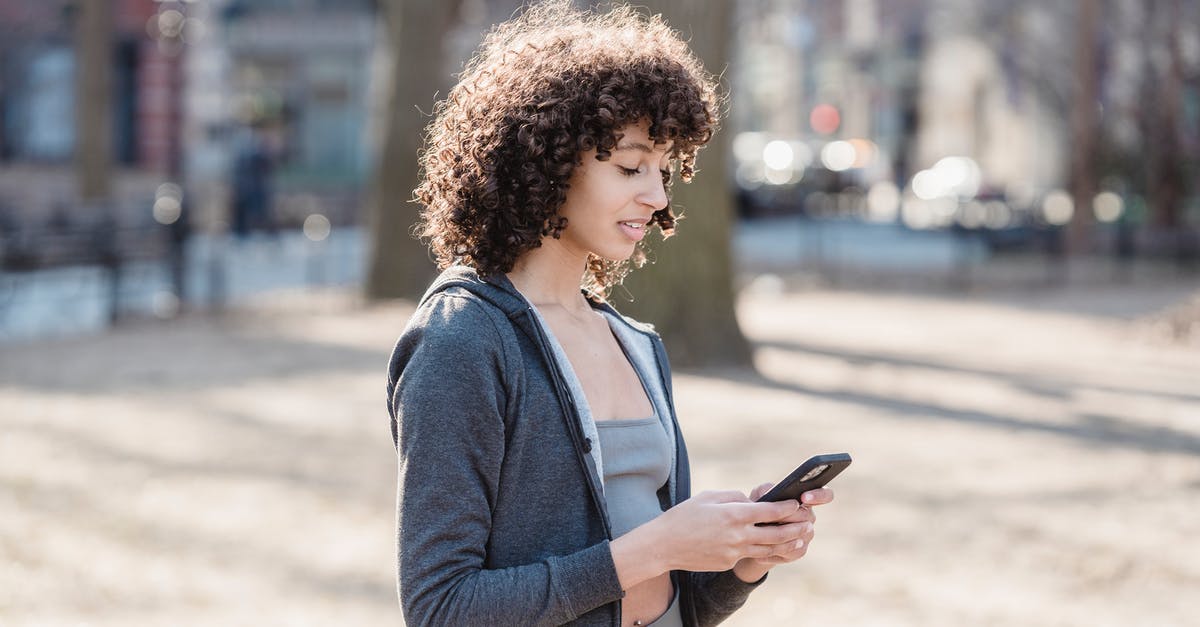 Can't send messages in Twitch Chat - Black woman using smartphone for sms in park