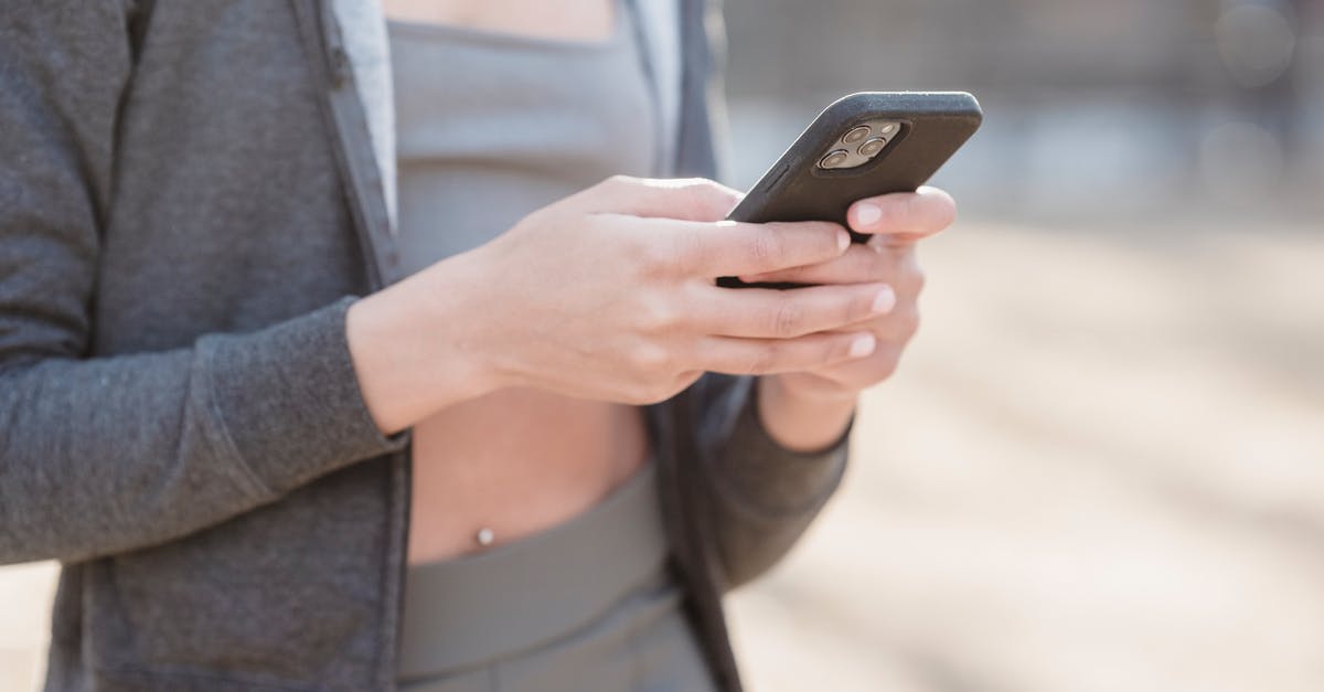 Can't send messages in Twitch Chat - Crop anonymous female in gray outfit using mobile phone on street on blurred background