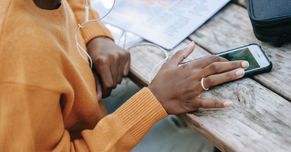 Can't send messages in Twitch Chat - Black woman touching screen of smartphone at table