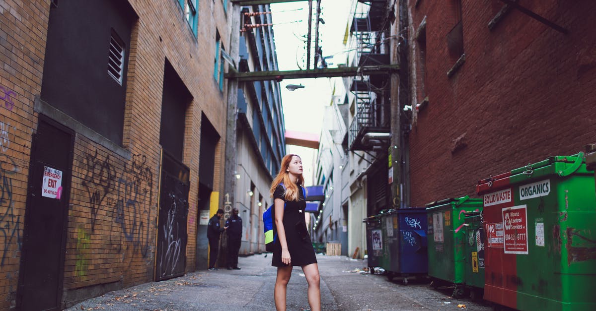 Can currently Mutinied buildings be targeted by Mutiny again? - Photo of a Woman Standing Between Buildings