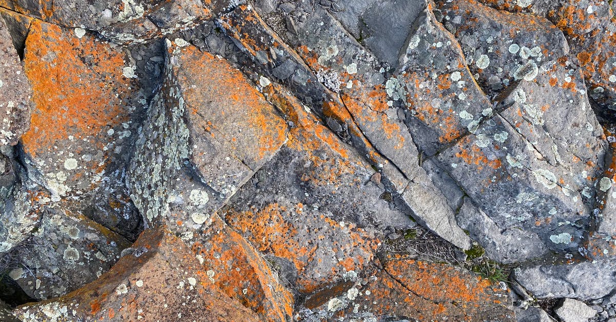 Can I de-rockify rocky terrain in SMAC - Top view of rough natural rock surface with cracks and orange rust as abstract  background