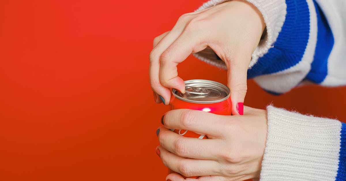 Can I get dunked on again? - Person Holding Can With Blue and White Knit Sweater