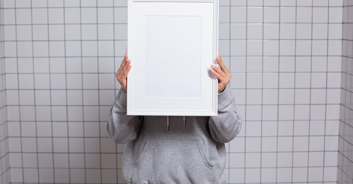 Can I hide new user's Donald medal? - Faceless person covering face with empty photo frame