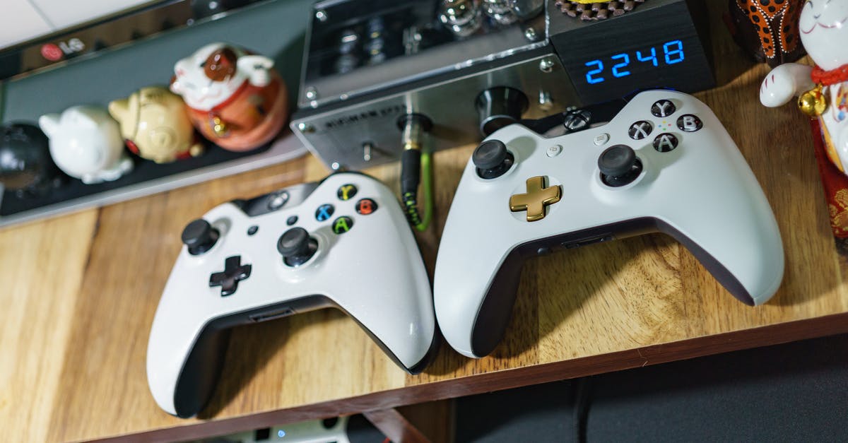 Can I partition a HDD for playing Xbox 360 games? - White Xbox One Controllers on Table