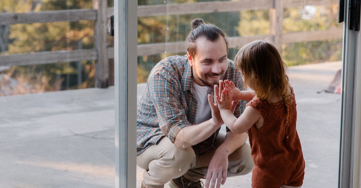 Can I play a downloaded game on a different account? - Little daughter and father having fun together