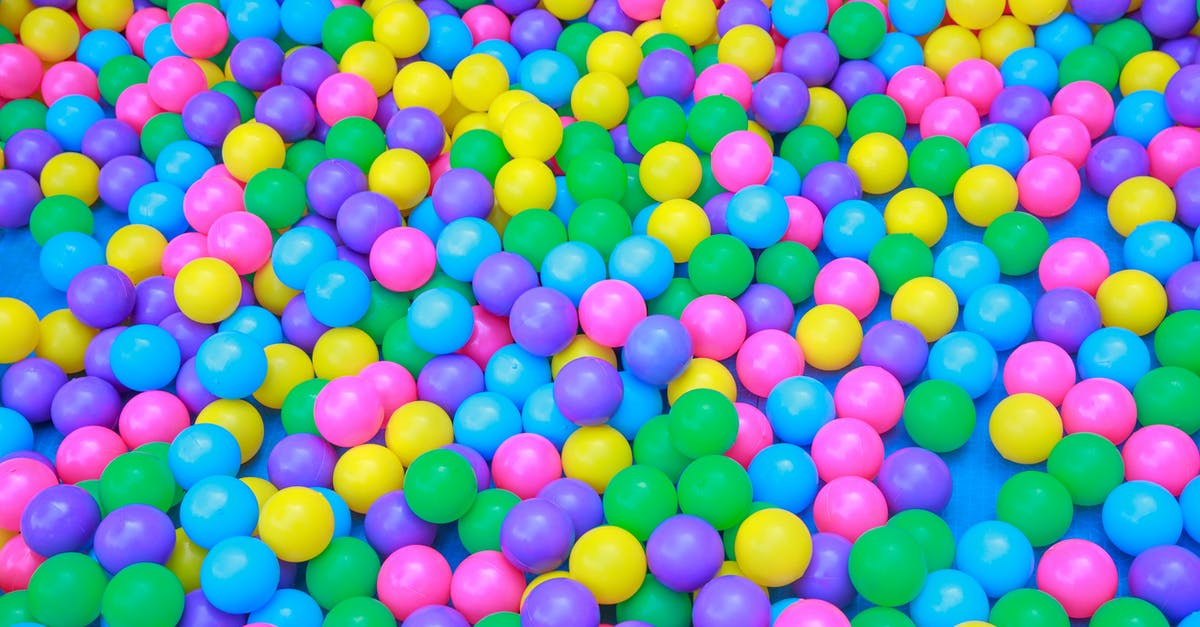 Can I play a downloaded game on a different account? - From above of colorful plastic balls in dry pool for kids to jump and play in playroom