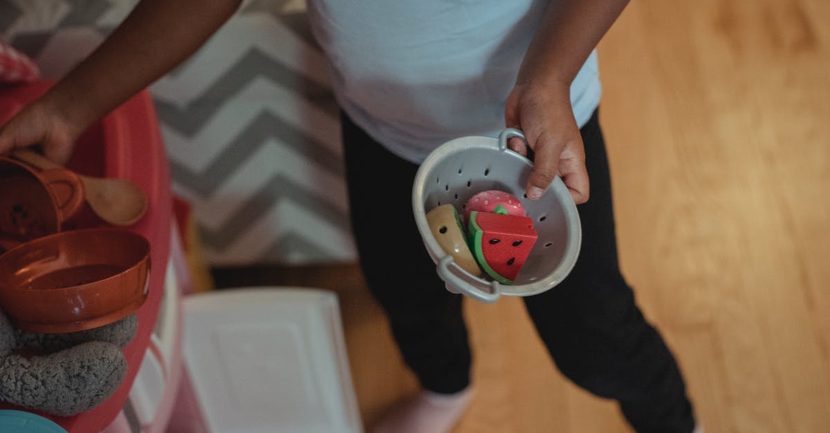 Can I play Google Doodle Fruit Games today? - Unrecognizable child playing with fake kitchenware