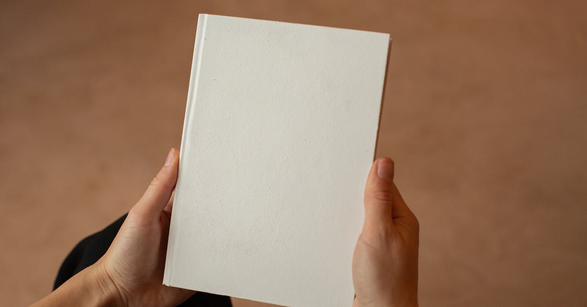 Can I read diary entries I missed? - Person holding hardcover book with blank cover