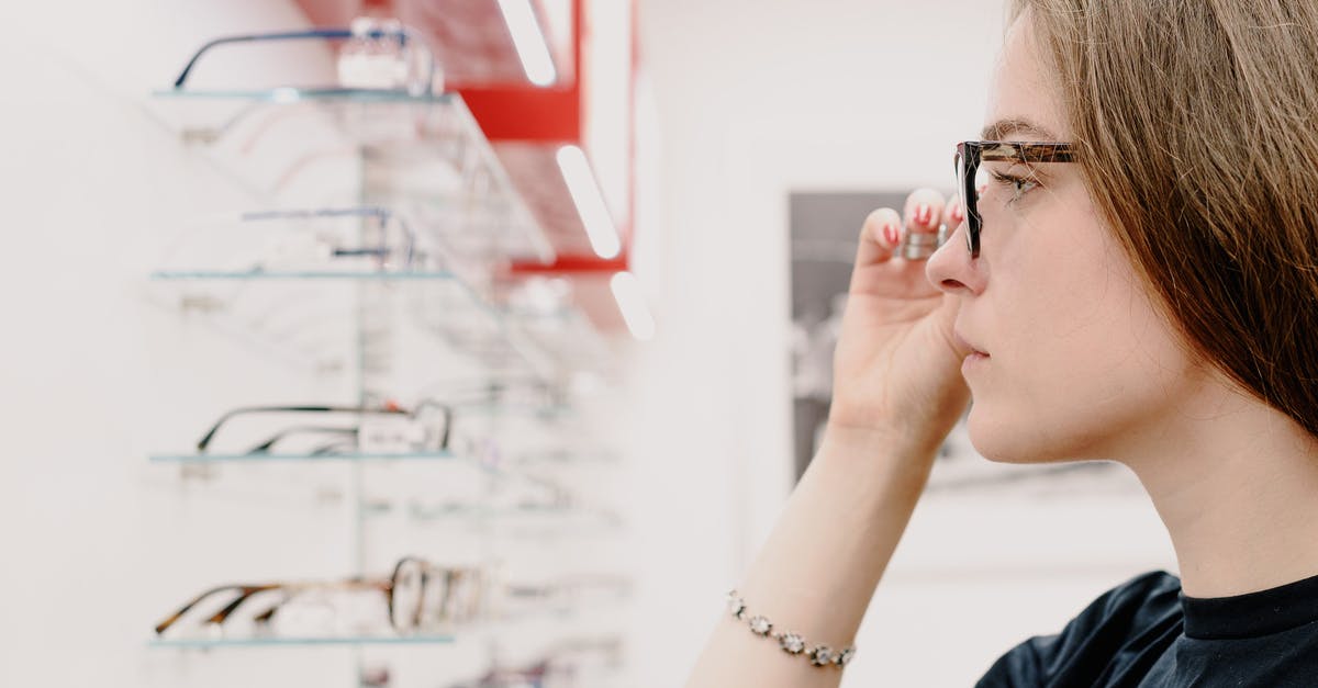 Can I skip the "try different control options" screen? - Side view of crop concentrated female customer putting on eyeglasses for improving eyesight while choosing rim in shop