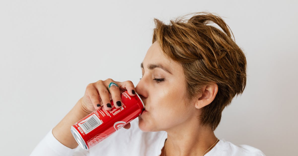 Can I undo red choices? - Thirsty woman enjoying coke from colorful can