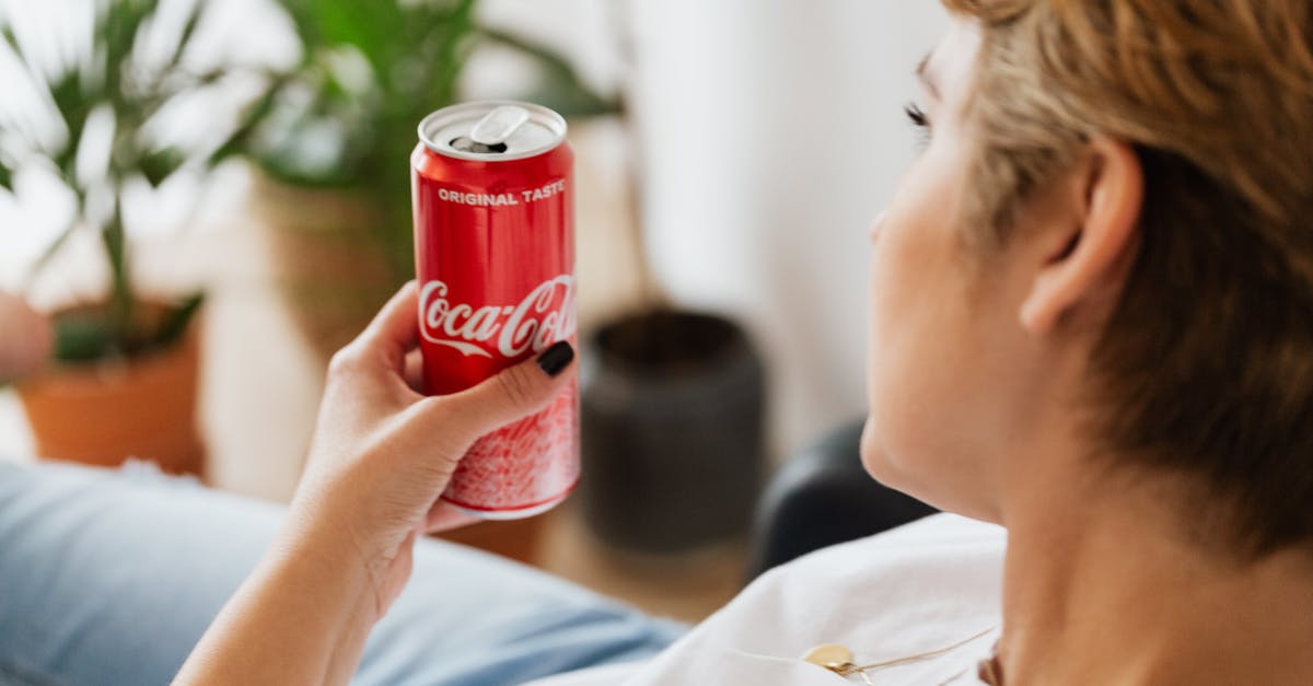 Can I undo red choices? - Crop anonymous woman resting at home with can of coke