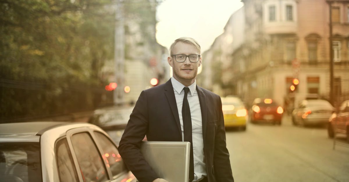 Can my PC run ARMA 3? [duplicate] - Determined smiling businessman with laptop on street