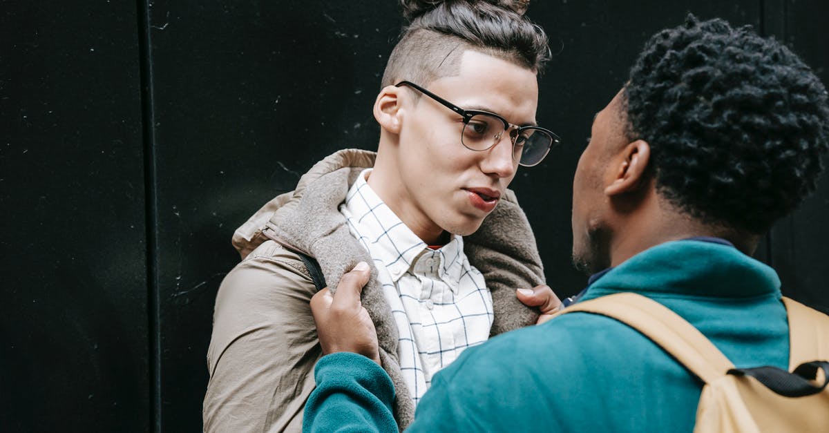 Can rebels attack each other? - Young multiracial male millennials in stylish clothes fighting together on street and looking at each other