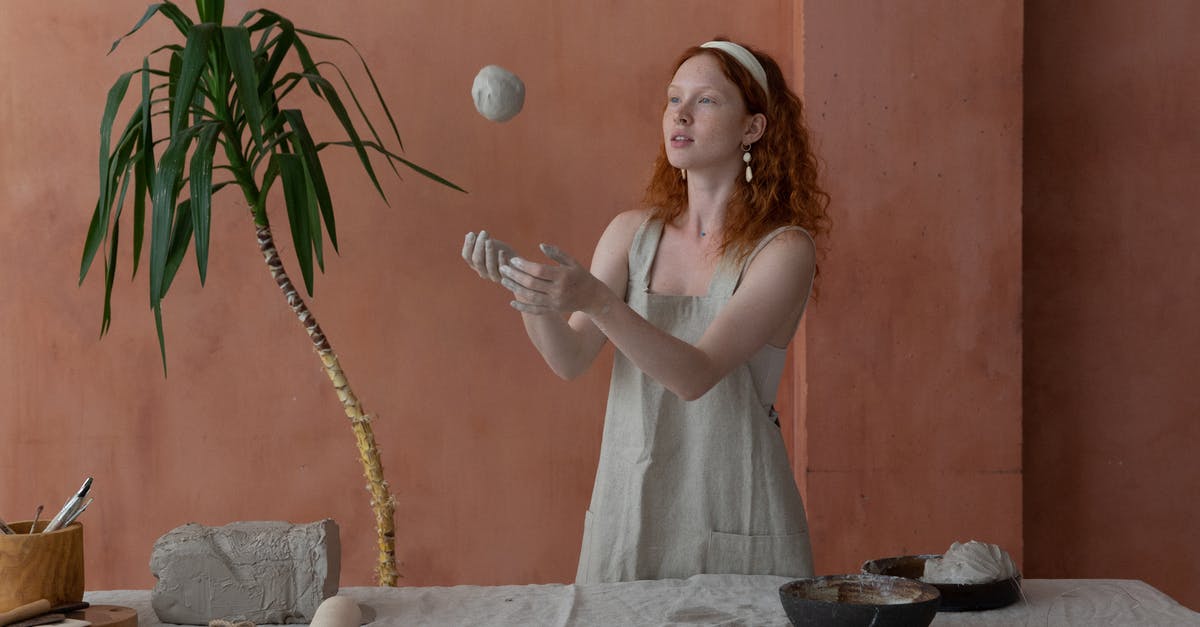 Can the Master Ball be traded as a held item? - Young skilled female ceramist wearing light apron throwing clay ball while making ceramic products in modern workshop