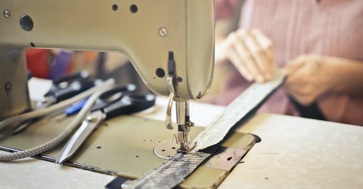 Can the Master Ball be traded as a held item? - Crop craftswoman in casual wear sitting at old fashioned sewing machine and stitching pieces of fabric while working in workshop