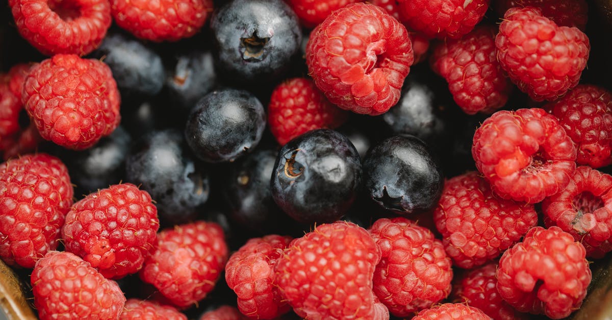 Can you pick up Pete's Watch in Walking Dead - Season 2 - Closeup heap of delicious fresh raspberries and blueberries picked from garden placed in bowl during harvest season in summer