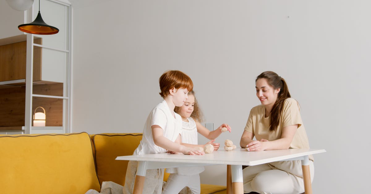 Can you play European N64 games on a Japanese console? - Woman in White Long Sleeve Shirt Sitting on Yellow Couch