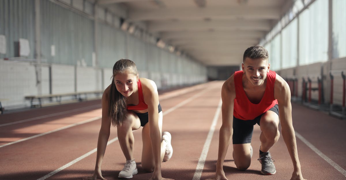 Change or swap fit skills damage with others - Men and Woman in Red Tank Top is Ready to Run on Track Field