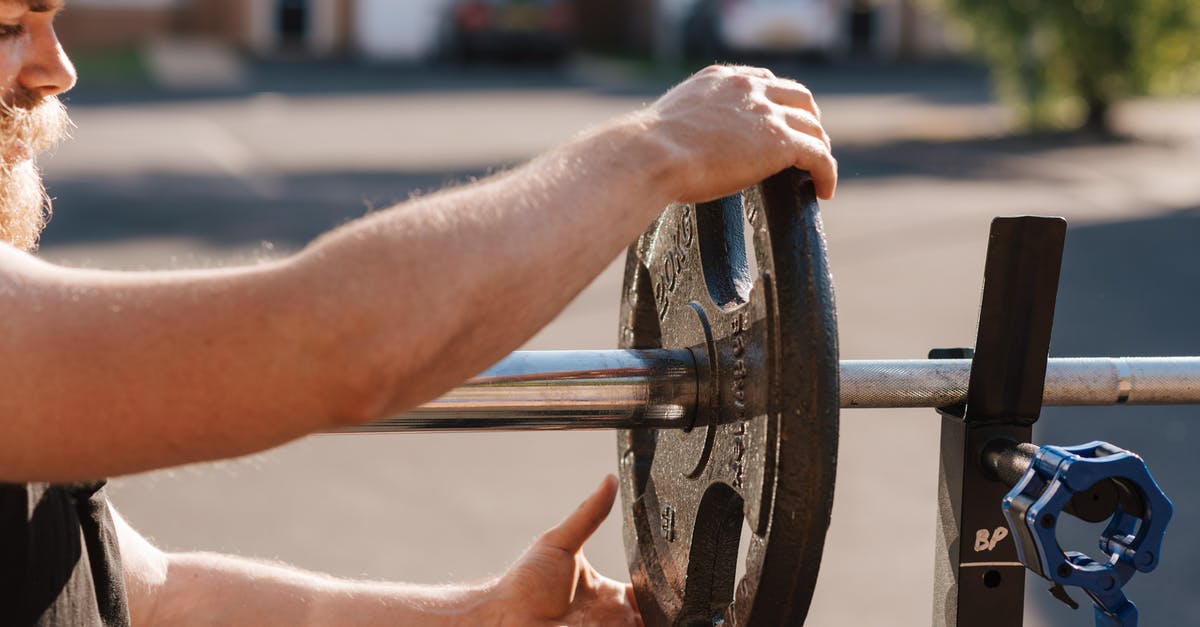 Change or swap fit skills damage with others - Man putting weight on metal barbell