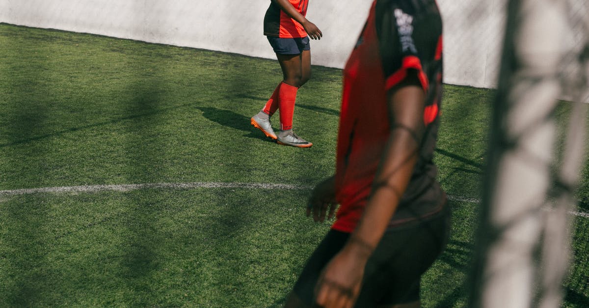 Change score based on score of killed player - Crop young African American female football player practicing with ball in training in sunny day Change score based on score of killed player - Crop young African American female football player practicing with ball in training in sunny day