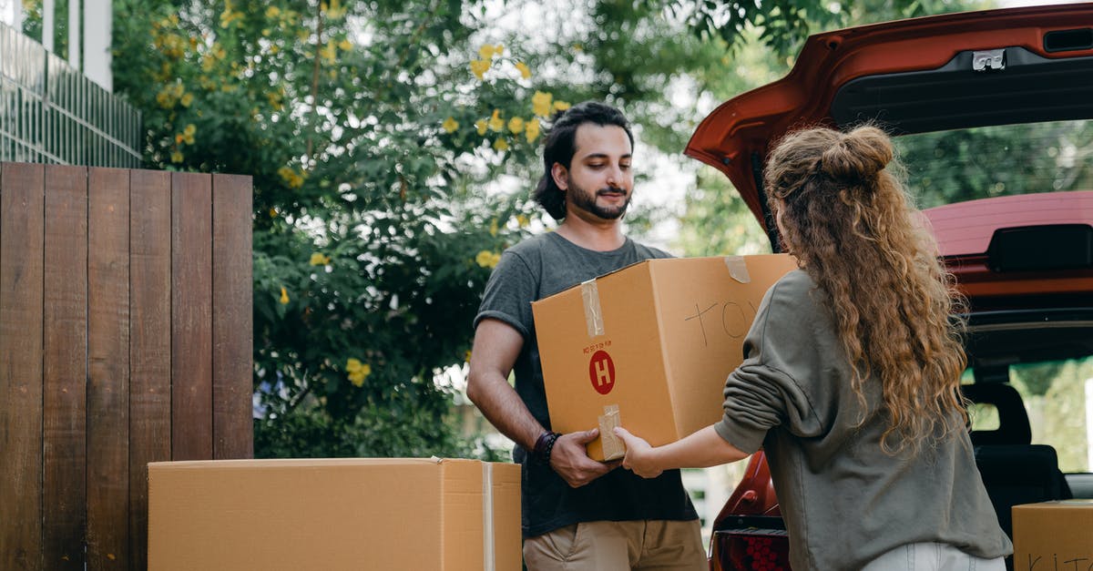 Changing NNID on Mario Edition New 3Ds - Boyfriend and girlfriend in casual wear helping each other with unpacking car while moving in together on sunny summer day