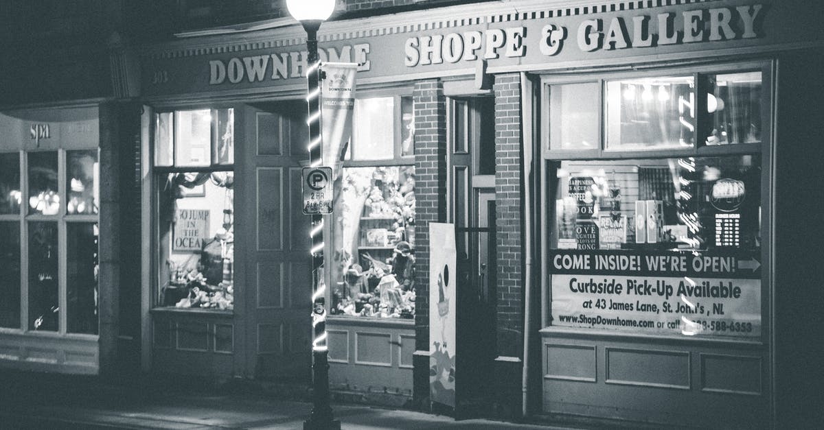 City Steward has died, how do I buy a house now? - Black and white of gallery facade with window display located in brick building near street lamp in city in evening time