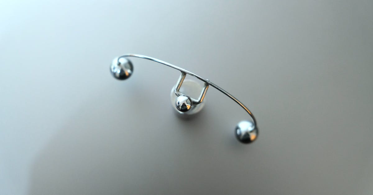 clear item from player's inventory - Top view of metal pendulum device placed on white table in psychiatrical clinic