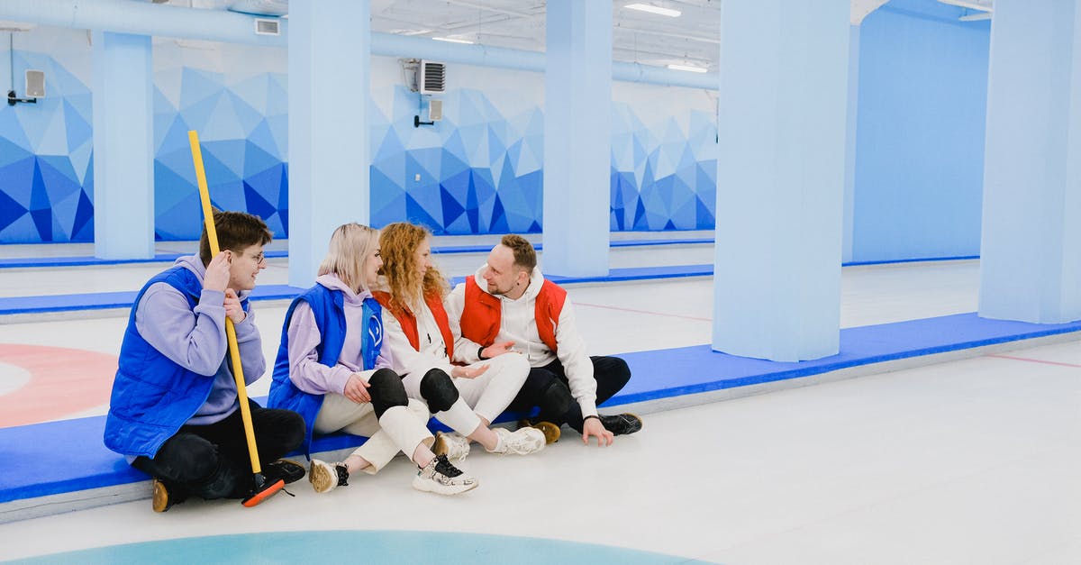 Command to say player coords in chat? - Sportsmen in red and blue waistcoats chatting on floor of spacious curling arena