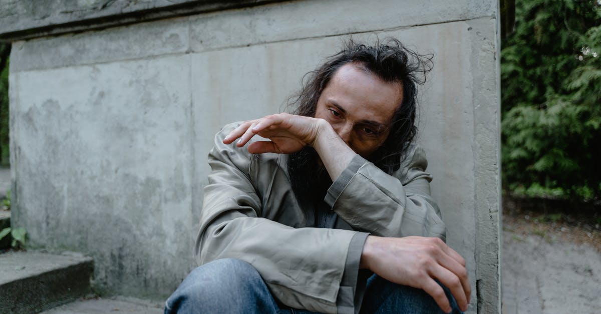 Conserving hunger while running? - Lonely Man Sitting on a Concrete Stairs