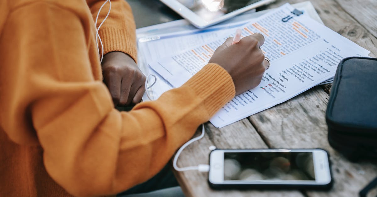 Correct use of the 'spawnactor' command? - From above of crop anonymous African American female in sweater studying and outlining words on paper at table with smartphone