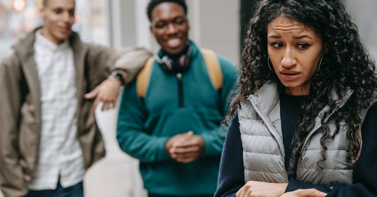 Could installing mods to Beat Saber have negative consequences? - Laughing multiracial teenage boys mocking at depressed young ethnic female standing on street after school