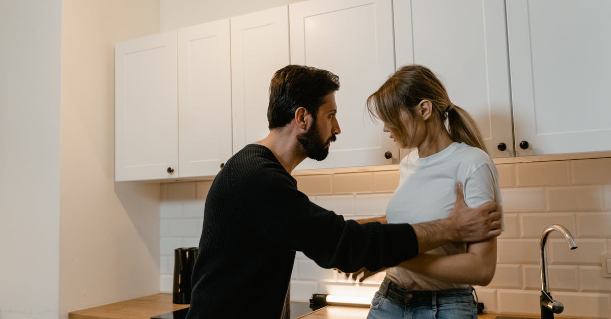 Could installing mods to Beat Saber have negative consequences? - Man and Woman Standing in Front of Kitchen Cabinet